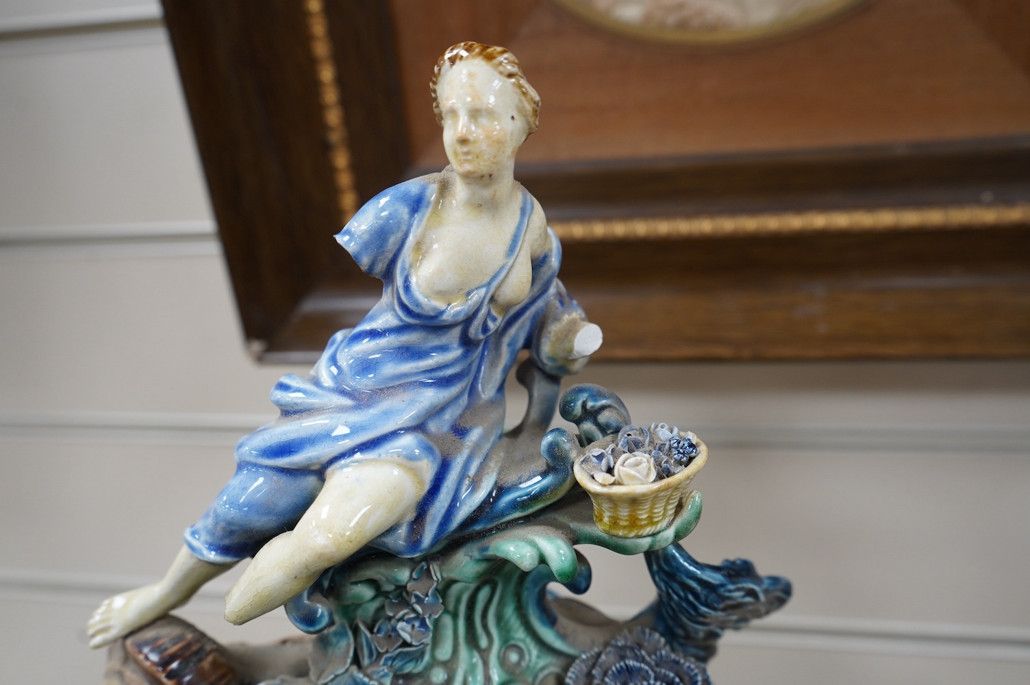 A Rorstrand pottery figural clock garniture with enamel dial and floral encrusted decoration, largest 57cm high. Condition - poor